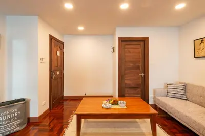 a living room with a couch and a coffee table at Maneeya Park Residence in Bangkok