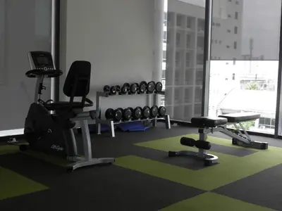 a gym with dumbbells and exercise equipment in a room at The SkyHouse Duplex - Luxury Home in Bangkok