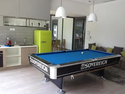 a kitchen and a pool table in a room at The SkyHouse Duplex - Luxury Home in Bangkok
