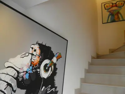 a painting of a man holding a megagraph at The SkyHouse Duplex - Luxury Home in Bangkok
