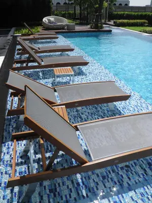 a row of benches in a swimming pool at The SkyHouse Duplex - Luxury Home in Bangkok