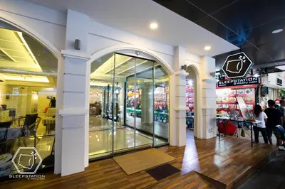a shopping mall with people walking in front of a store at Sleepstation at Pratunam in Bangkok