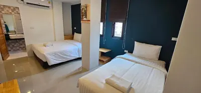 a small room with two beds and a bathroom at Sleepstation at Pratunam in Bangkok