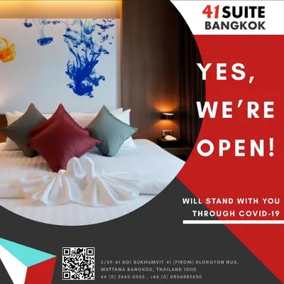 a poster for a hotel room with a bed with colorful pillows at 41 Suite Bangkok in Bangkok