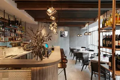 a dining room with a table and some chairs at Somerset Maison Asoke Bangkok in Bangkok