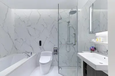 a bathroom with a shower and a toilet and a sink at Somerset Maison Asoke Bangkok in Bangkok