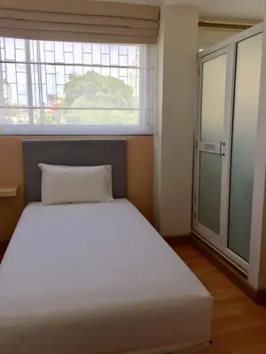 a bed in a room with a large window at Nine Place Sukhumvit 40 in Bangkok