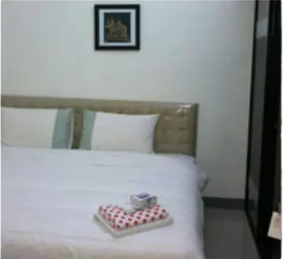 a bed with a red and white plate on it at Nine Place Sukhumvit 40 in Bangkok