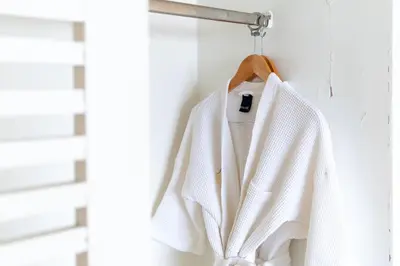 a white sweater hanging on a wall at Summit Pavilion Hotel in Bangkok