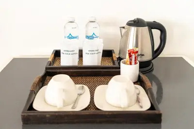 a tray with a tea set and cups and a coffee maker at Summit Pavilion Hotel in Bangkok