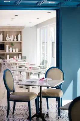 a group of tables and chairs in a room at Hotel Tranz in Bangkok