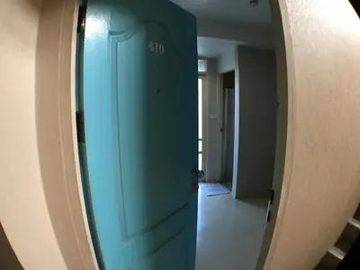 a blue door in a room with a hallway at Roof View Place in Bangkok