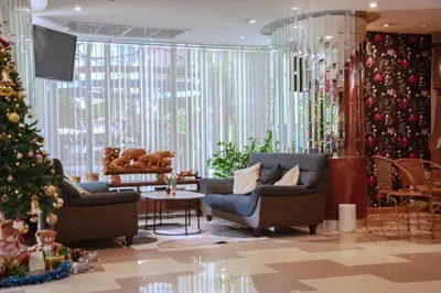 a lobby with a christmas tree and two couches at The Sunreno Hotel Bangkok in Bangkok