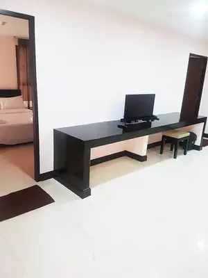 a black desk with a laptop on top of it at Mok Mek 72 in Bangkok