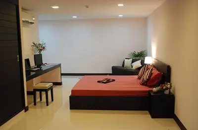 a bedroom with a bed and a couch in a room at Mok Mek 72 in Bangkok