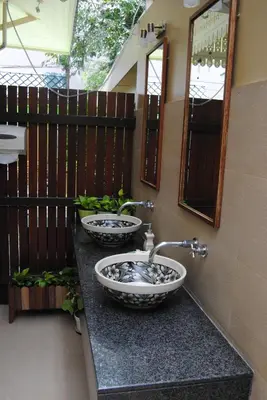 two sinks on a counter in a bathroom at Baan Dinso in Bangkok