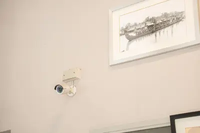 a picture of a pier on a wall with a camera at Ratchadamnoen Residence in Bangkok