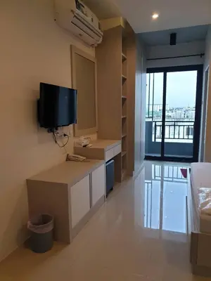a living room with a tv on the wall at DB Plus 2 in Bangkok