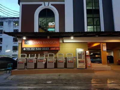 a row of parking meters in front of a building at DB Plus 2 in Bangkok