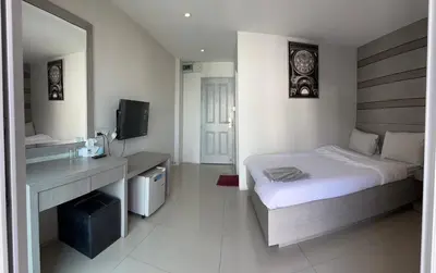 a hotel room with a bed and a mirror at DB Plus 2 in Bangkok