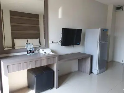 a kitchen with a desk with a television and a refrigerator at DB Plus 2 in Bangkok