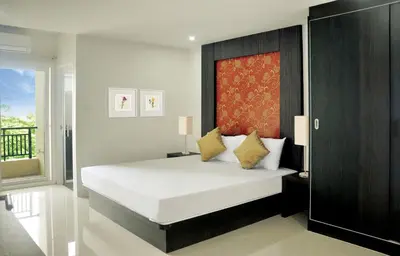 a bedroom with a large white bed and a window at DB Plus 1 in Bangkok