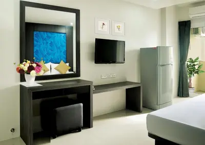 a living room with a television and a refrigerator at DB Plus 1 in Bangkok