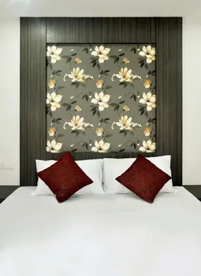 a bedroom with a white bed with red pillows at DB Plus 1 in Bangkok