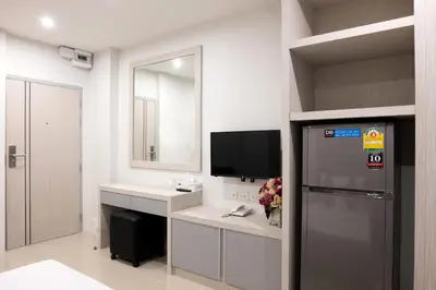 a bathroom with a refrigerator and a tv in it at DB Plus 5 in Bangkok