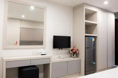 a kitchen with a sink and a refrigerator and a tv at DB Plus 5 in Bangkok