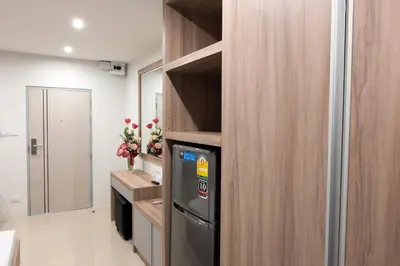 a kitchen with a dishwasher in a wooden wall at DB Plus 5 in Bangkok