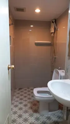 a bathroom with a white toilet and a sink at Panoramic City View Room at Silom in Bangkok