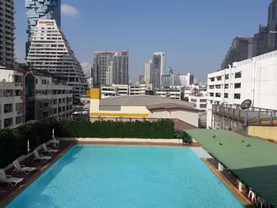 a large swimming pool on top of a building at Panoramic City View Room at Silom in Bangkok
