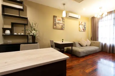 a living room with a couch and a table at Greenview Ekkamai10 Suite in Bangkok