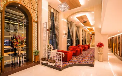 a lobby of a store with red couches and flowers at Grand Lord Boutique Hotel -Srinakarin in Bangna