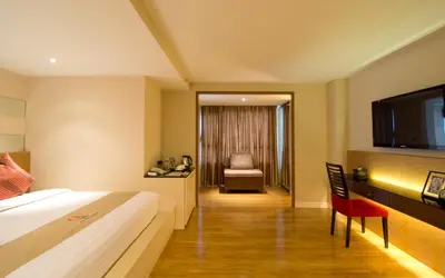 a hotel room with a bed and a flat screen tv at Grand Lord Boutique Hotel -Srinakarin in Bangna