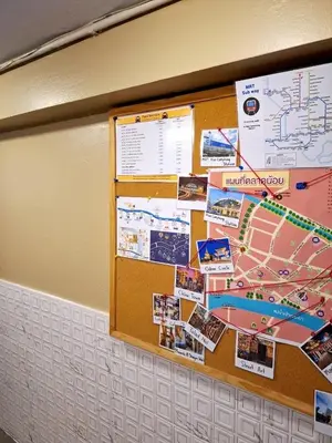 a bulletin board with a map and pictures on it at Four Sisters Homestay in Bangkok