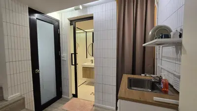 a bathroom with a sink and a mirror at Wang Lang Hostel in Bangkok