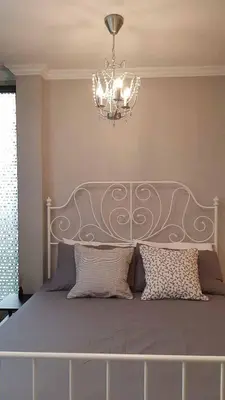 a bedroom with a bed with a chandelier at Wang Lang Hostel in Bangkok