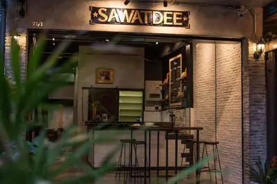 a bar with stools in front of a restaurant at Sawatdee Guesthouse the Original in Bangkok