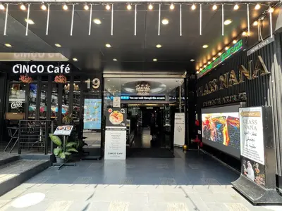 a chino cafe with lights on the front of a building at Fortuna Hotel in Bangkok