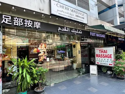 a store front of a store with signs on it at Fortuna Hotel in Bangkok