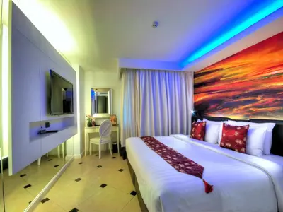 a hotel room with a bed and a painting on the wall at Aspira Skyy Sukhumvit 1 in Bangkok