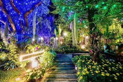 a painting of a garden at night with lights at Bangkok Oasis Hotel in Bangkok