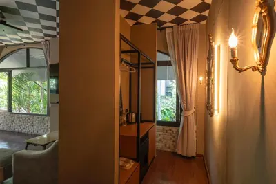 a living room with a checkered ceiling at Bangkok Oasis Hotel in Bangkok