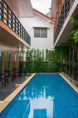 a swimming pool in the middle of a building at Resort V - MRT Huai Khwang in Bangkok