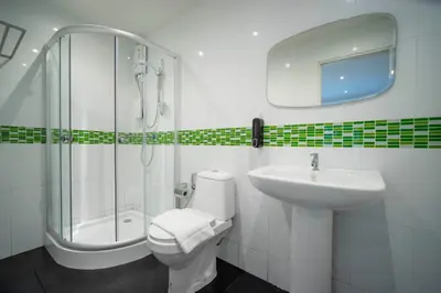 a bathroom with a toilet and a sink and a shower at Resort V - MRT Huai Khwang in Bangkok