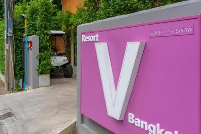 a purple sign with the letter v on it at Resort V - MRT Huai Khwang in Bangkok
