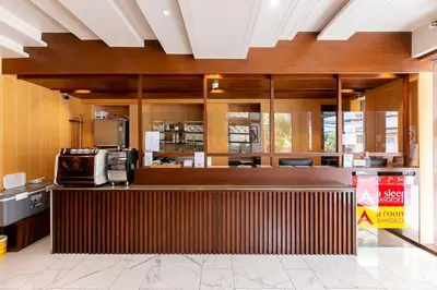 a restaurant with a counter with a microwave at A Room Bangkok Sathorn in Bangkok