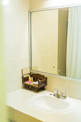 a bathroom with a sink and a mirror at King Royal 2 in Bangkok